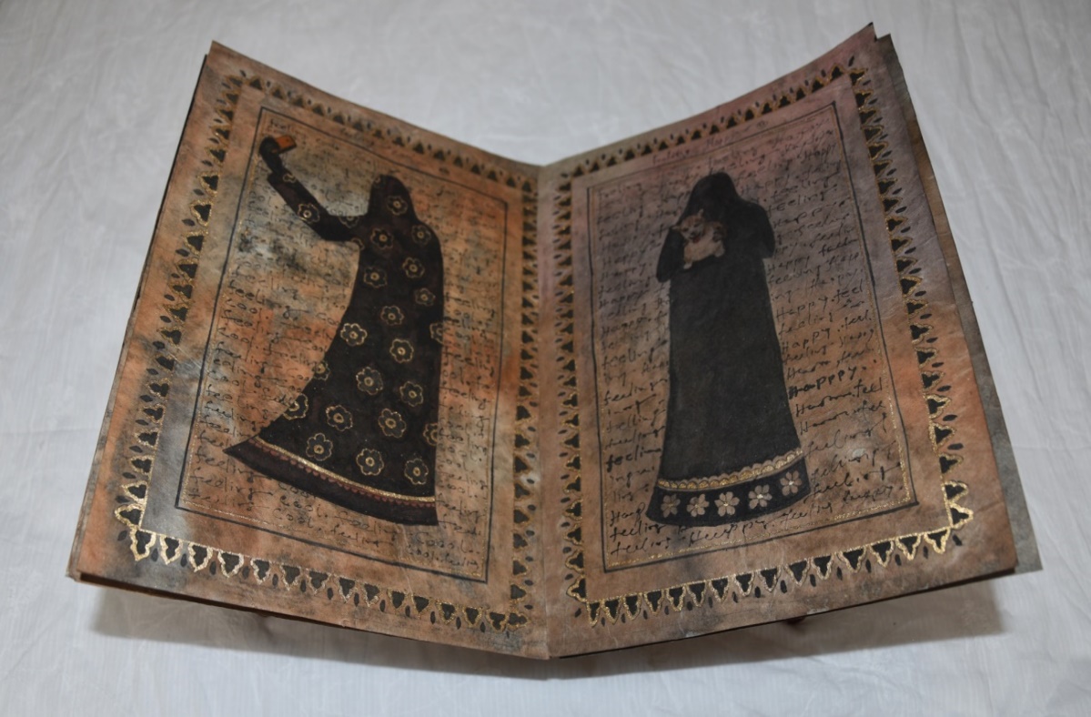Exuberant Anonymity (detail view), watercolour on Wasli board with Rehal stand, 2018. An open illustrated book laid flat: the left page bears a fully veiled figure in a patterned dark robe holding a phone to photograph herself; the right page depicts a second veiled figure.